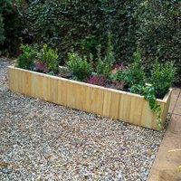 Wooden planter box with shiplap design, filled with green plants, measuring 5'11 x 1'3, natural finish.