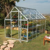 Silver polycarbonate greenhouse with clear panels, pitched roof, and walk-in door, housing plants and flowers inside.