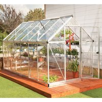 Silver polycarbonate greenhouse with clear panels, pitched roof, and metal frame on wooden deck.