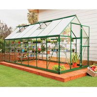 Green Palram Canopia greenhouse with clear polycarbonate panels and green metal frame on wooden deck.
