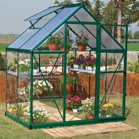 Green Palram Canopia greenhouse with clear polycarbonate panels, sloped roof, and open vent, filled with potted plants.