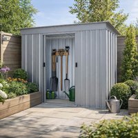 Silver Yardmaster Pent Metal Shed with vertical ridges, sliding doors, and garden tools inside, surrounded by greenery.
