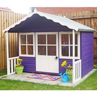 Purple wooden garden playhouse with white trim, scalloped roof, and windowed door, surrounded by potted plants.