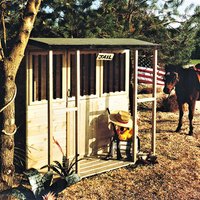 Shire Jailhouse Kids Wooden Playhouse, 6'x6', natural wood finish, barred windows, flat roof, front porch.