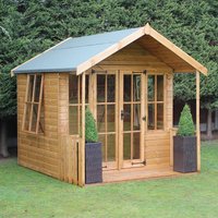 Wooden summer house with glass doors, side windows, and a green roof, flanked by two potted plants.
