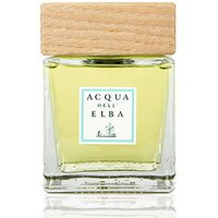 Square glass bottle with light yellow liquid, wooden cap, and Acqua dell'Elba label on the front.