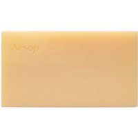 Beige rectangular Aesop body cleansing slab soap with embossed brand name on the surface.