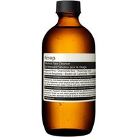 Amber bottle of Aesop Fabulous Face Cleanser with black screw cap and white label detailing ingredients.