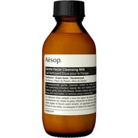 Amber bottle of Aesop Gentle Facial Cleansing Milk, black cap, white label with text, 100 ml size.