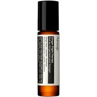Amber glass roll-on bottle with black cap, labeled "Aesop Ginger Flight Therapy" in white and black text.