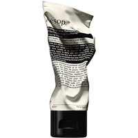 Aesop Purifying Facial Exfoliant Paste in a crumpled beige tube with black text and a black cap, 75 ml size.
