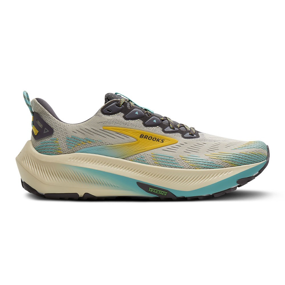 Light gray trail running shoes with a textured upper, featuring blue and yellow accents, a cushioned sole, and a rugged outsole for traction.