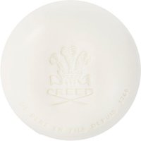 White round soap with embossed Creed logo and text, "Silver Mountain Water Savon 150 g," elegant and minimalist design.