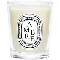 Clear glass jar with white wax, featuring Diptyque's oval label and "Ambre" text in black.
