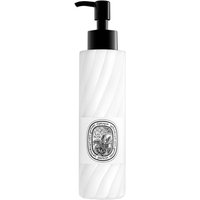 White Diptyque Eau Rose lotion bottle with black pump and ornate oval label.