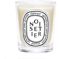 Diptyque Noisetier candle in clear glass jar with black and white oval label, 190 g, creamy wax.