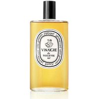 Amber liquid in clear bottle with white label, black text, and Diptyque branding, "Vinaigre de Toilette 80".