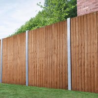 Forest 6' x 5' vertical closeboard fence panel, natural wood finish, supported by metal posts, set against greenery.