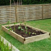 Wooden rectangular raised garden bed with soil and young plants, featuring a natural finish and corner posts.