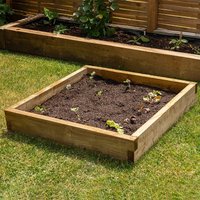 Wooden Forest Caledonian small raised bed, 0.9m square, filled with soil and young plants, set on grass.