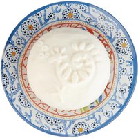 White Fragonard soap with floral imprint on a blue and red patterned ceramic soap dish.