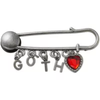 Goth-themed Crocs Jibbitz charm, silver safety pin with dangling letters "GOTH" and a red heart charm.