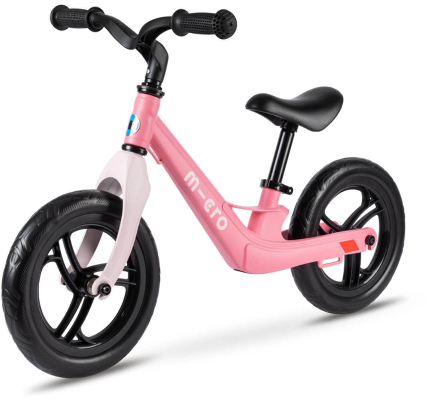 Pink balance bike with a lightweight frame, black seat, and rubber tires, featuring a minimalist design and adjustable handlebars for young riders.