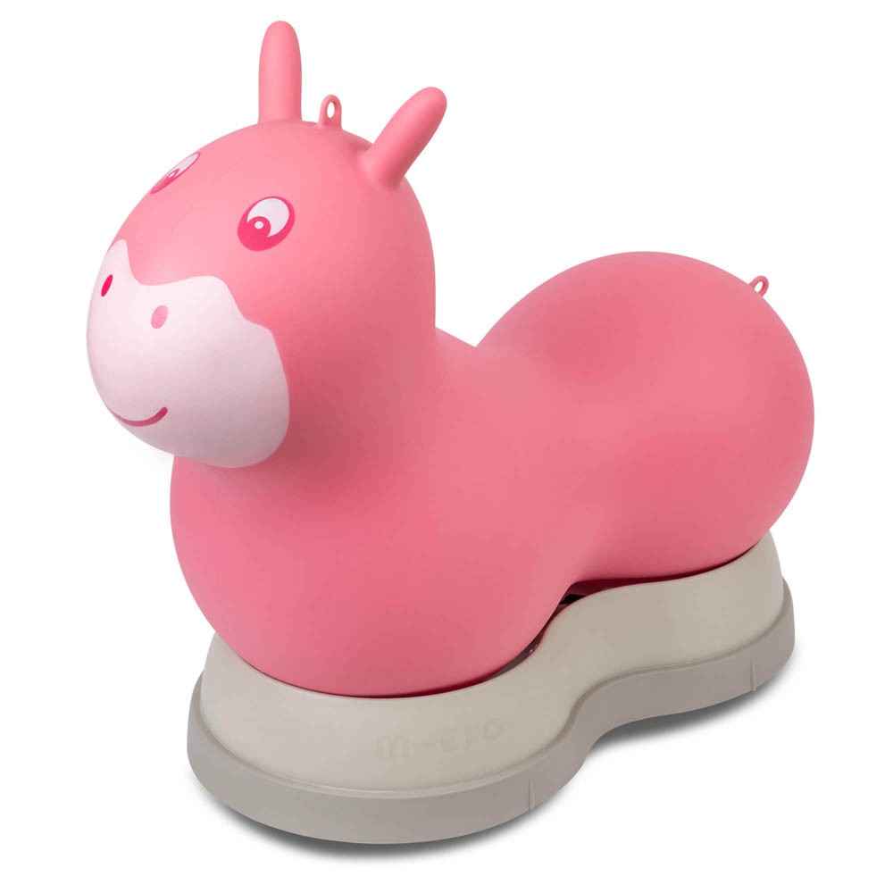 A pink, inflatable hopper shaped like a cartoonish horse with a smiling face, resting on a sturdy gray base designed for stability.