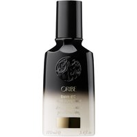Black and gold gradient Oribe Balm d’Or bottle, 100 ml, with embossed logo and sleek, cylindrical cap.
