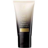 Black and gold Oribe shampoo tube, travel size, with gold cap and elegant branding.