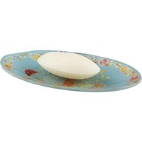 Blue oval glass plate with floral design, holding a white oval soap bar by Ortigia.