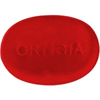Red oval Ortigia Melograno glycerine soap with embossed brand name.