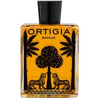 Clear glass bottle with black cap, featuring Ortigia Zagara Bath Oil, palm tree and leopard design on amber liquid.