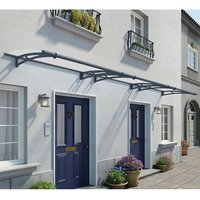 Grey clear door canopy with arched support brackets and sleek design over blue doors on a light-colored building.