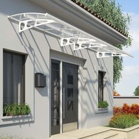 White Palram Canopia Bordeaux 4460 door canopy with curved clear panels and decorative brackets over a modern entrance.