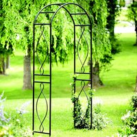 Black metal garden arch with curved top and decorative scrollwork, set in a lush green garden.