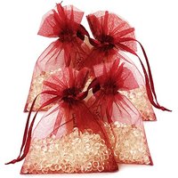 Red organza bags filled with floral scented granules, tied with matching ribbons.