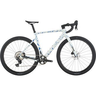 White carbon gravel bike with blue splatter design, featuring drop handlebars, wide tires, and a sleek frame, ideal for off-road and gravel riding.