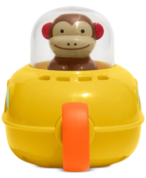 Bright yellow submarine bath toy with a smiling monkey figure inside a clear dome, featuring an orange handle and designed to enhance fine motor skills. Phthalate-free material.