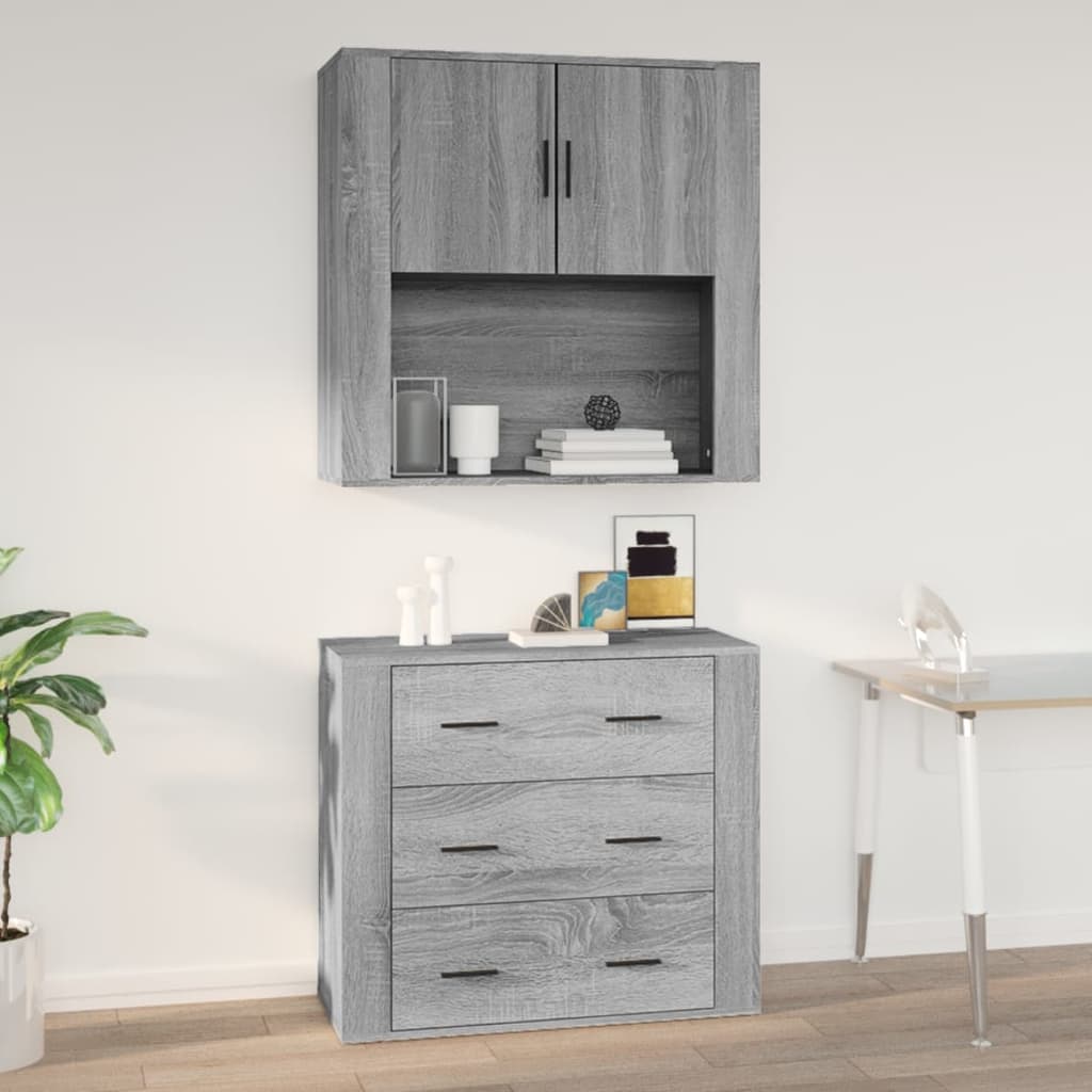 Grey Sonoma wall cabinet made of engineered wood, featuring two upper doors and an open shelf, with a lower section containing four drawers, set against a light wall.