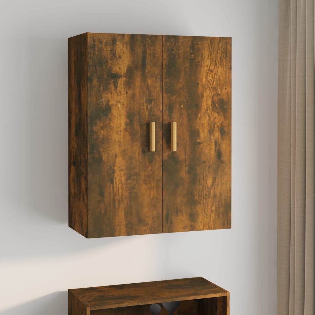 Hanging wall cabinet in smoked oak finish, featuring two doors with gold handles, measuring 69.5x34x90 cm, mounted against a light wall.