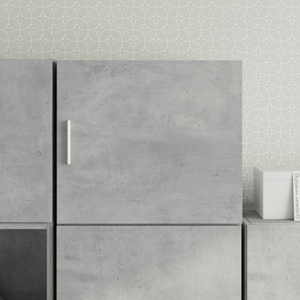 Concrete grey wall cabinet made of engineered wood, featuring a sleek design with a minimalist handle, set against a patterned light green wall.