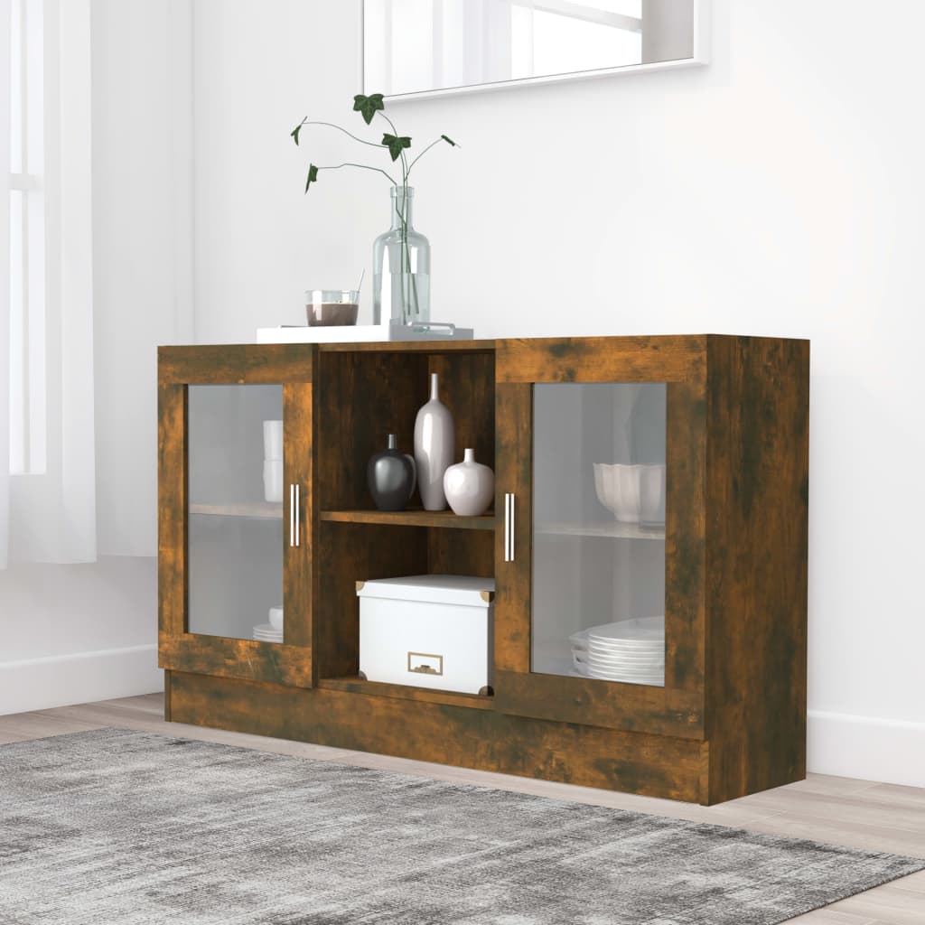 Smoked oak vitrine cabinet in brown engineered wood, featuring two glass doors, open middle shelf, and sleek metal handles, set against a light wall and rug.