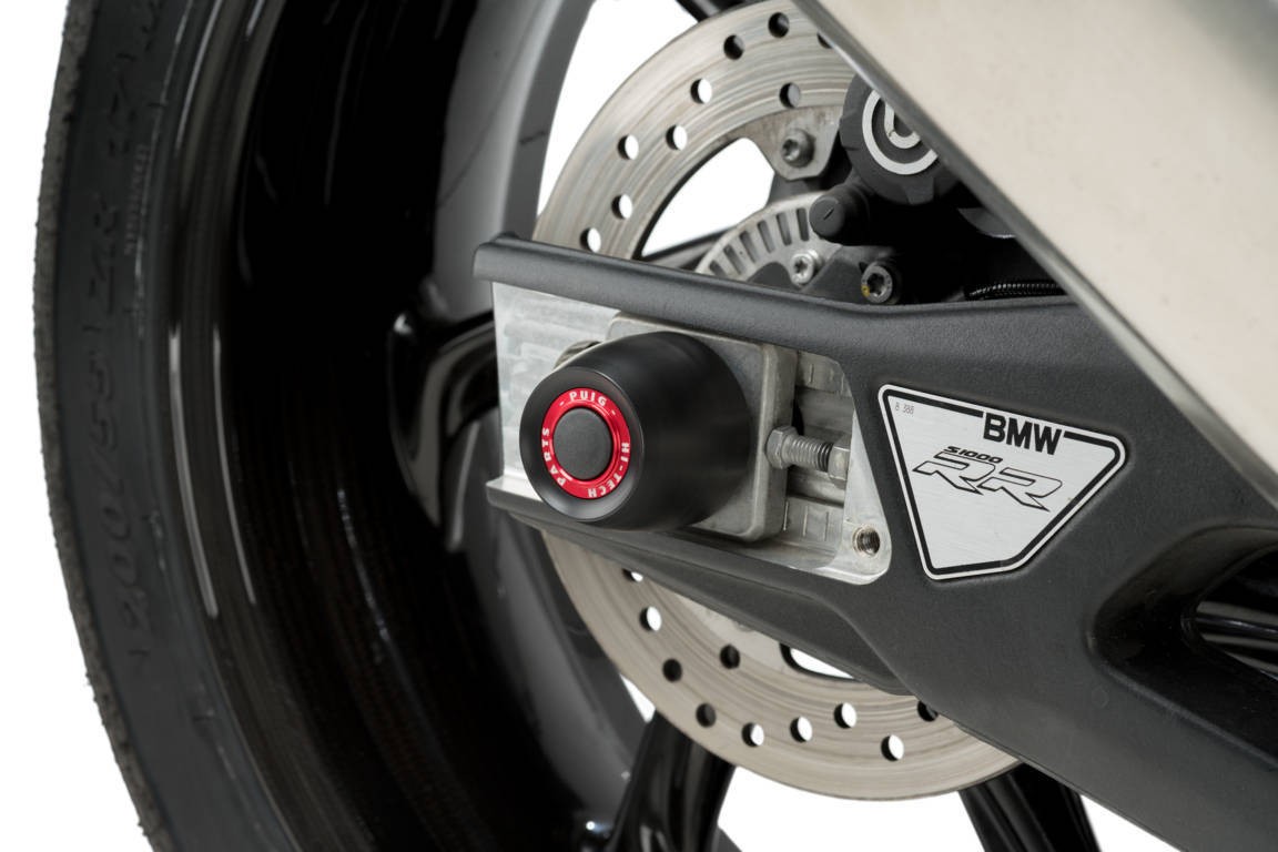 Black Puig PHB19 swing arm protector for BMW R Nine T (2021-2024) featuring a sleek design, metallic finish, and a prominent red accent on the securing bolt.