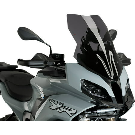 Puig Touring Screen for BMW M1000 XR 2024-2025 in dark smoke, featuring a sleek design, aerodynamic shape, and a glossy finish, mounted on a gray motorcycle with black accents.