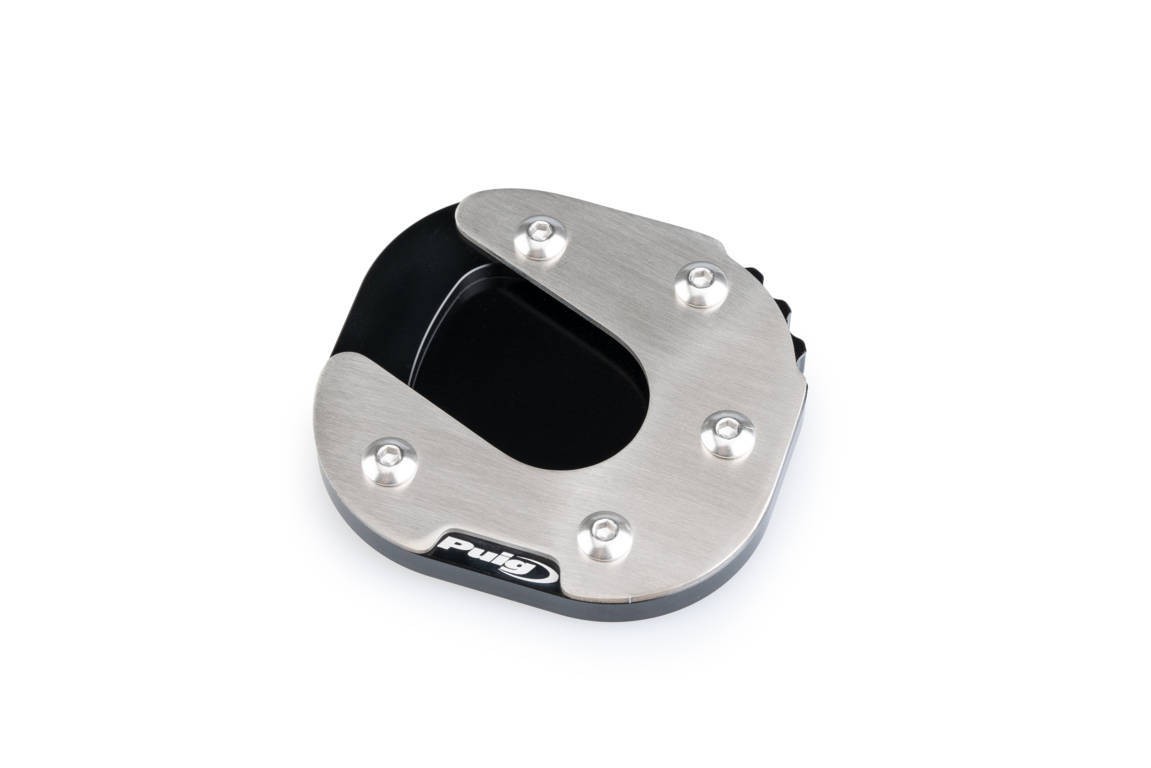 Black Puig kickstand extension pad with a stainless steel top, featuring four silver screws and a curved design, specifically for Honda XL750 Transalp models from 2023 to 2025.