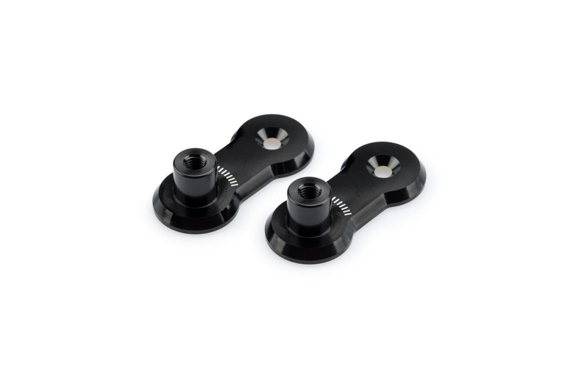 Black aluminum adjustable footpegs relocation adaptors with a sleek design, featuring two mounting holes and a polished finish, compatible with KTM 1050 Adventure models from 2015-2016.