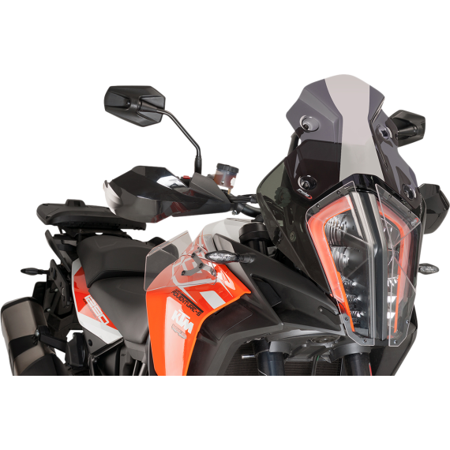 Dark smoke Puig 9716F racing windscreen, featuring a sleek design and durable material, mounted on a motorcycle with black and orange accents, enhancing aerodynamics and style.