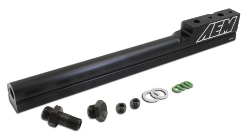 Black anodized aluminum fuel injector rail by AEM Electronics, featuring multiple mounting holes, accompanied by metal fittings and O-rings in green and silver.