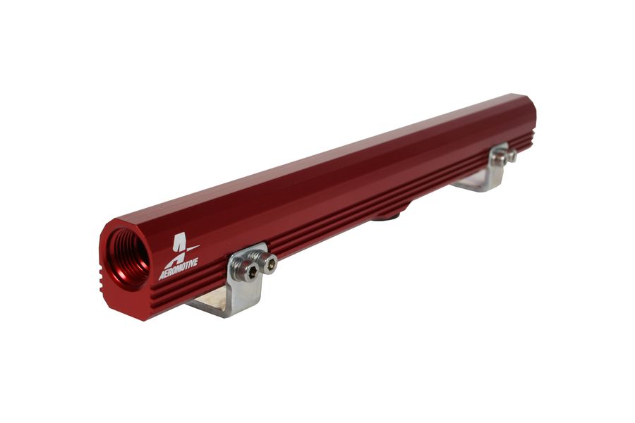 Red anodized aluminum billet fuel rail featuring precision machining, mounting brackets, and inlet/outlet ports, designed for VW Audi 1.8L Turbo applications.